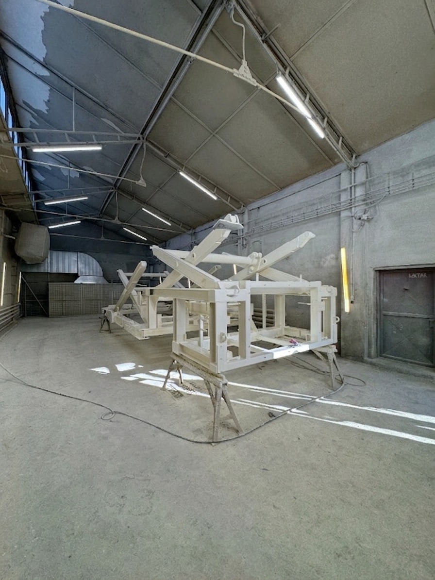 White primed welded steel structure in a painting facility