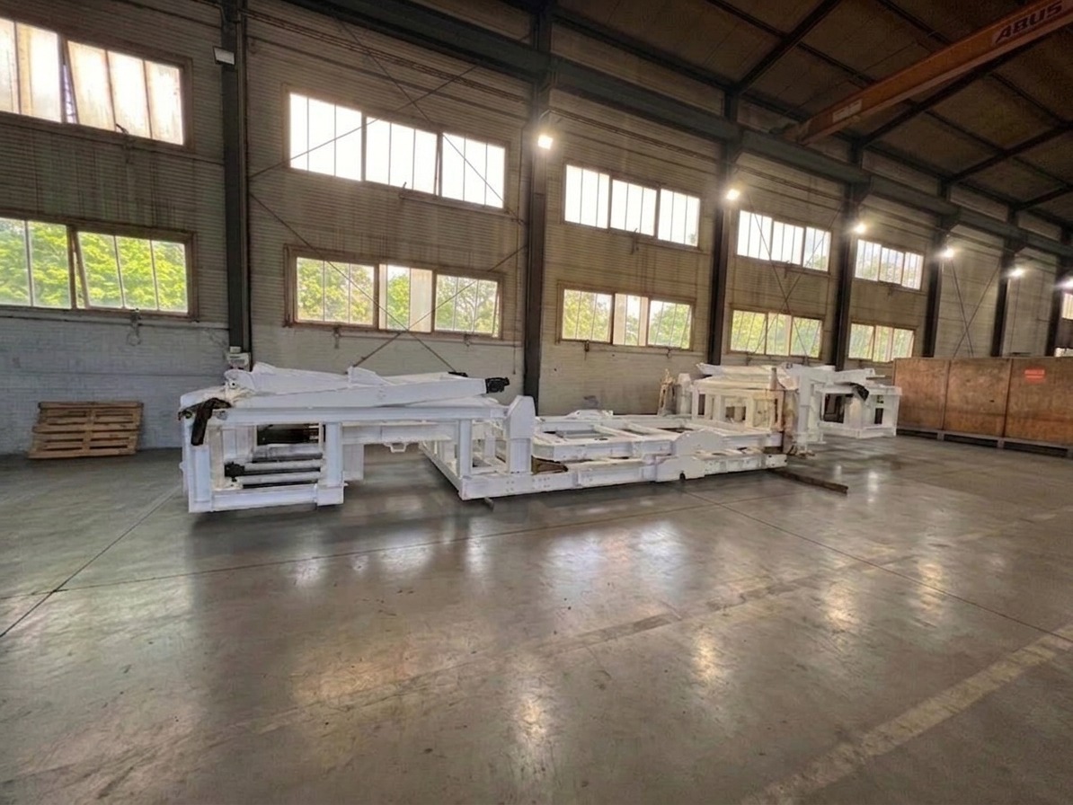 Large white primed steel structure in a production hall